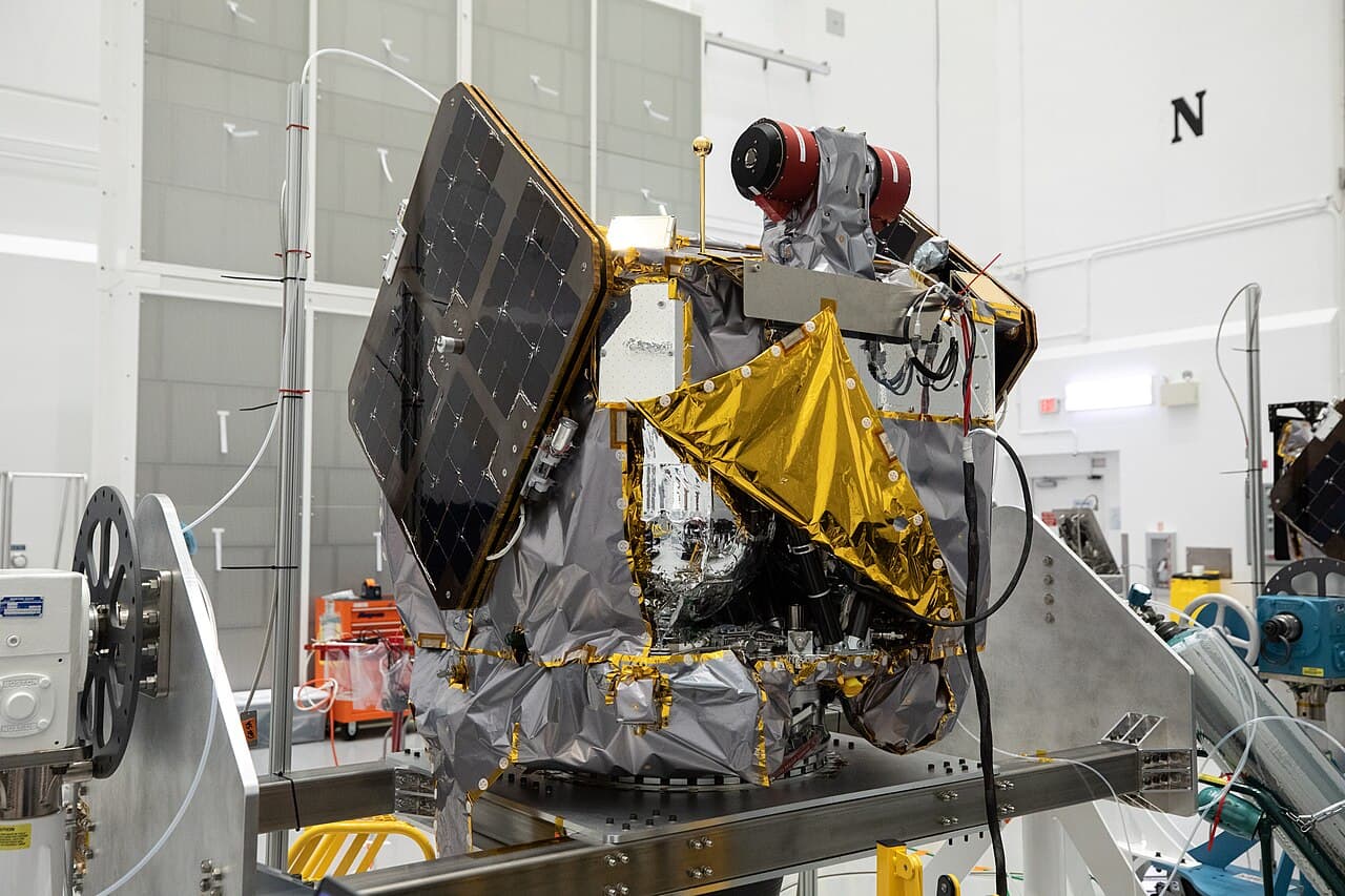 The two identical ESCAPADE orbiters, Blue and Gold, standing on dollies in a high bay of the Astrotech Space Operations Facility near Kennedy Space Center on 22 August 2024, where they were inspected and processed after delivery.