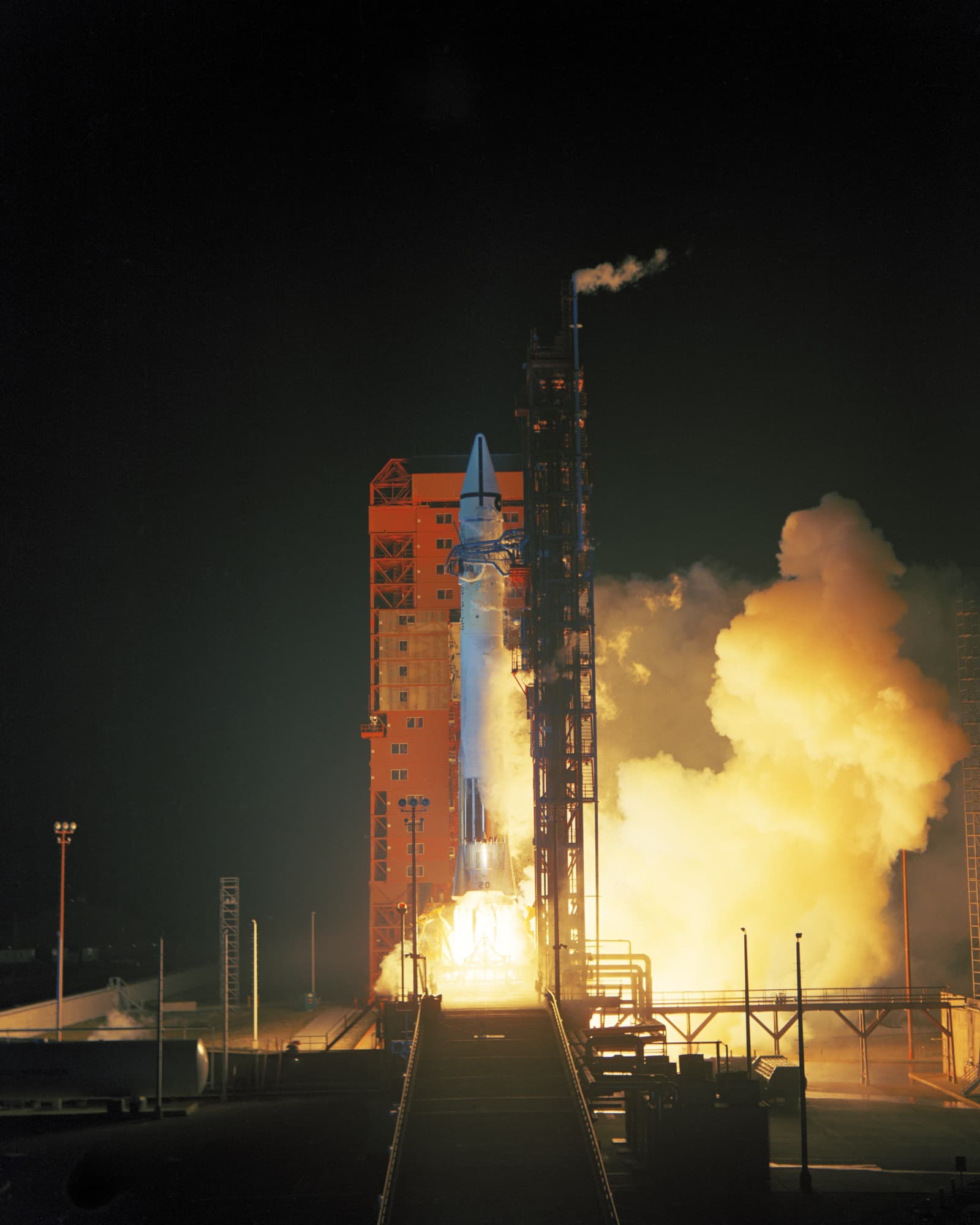 The Atlas-Centaur carrying Mariner 6 lifting off from Launch Complex 36B at Cape Kennedy at 8:29 p.m. EST on 24 February 1969, the pad and service tower lit by the exhaust.