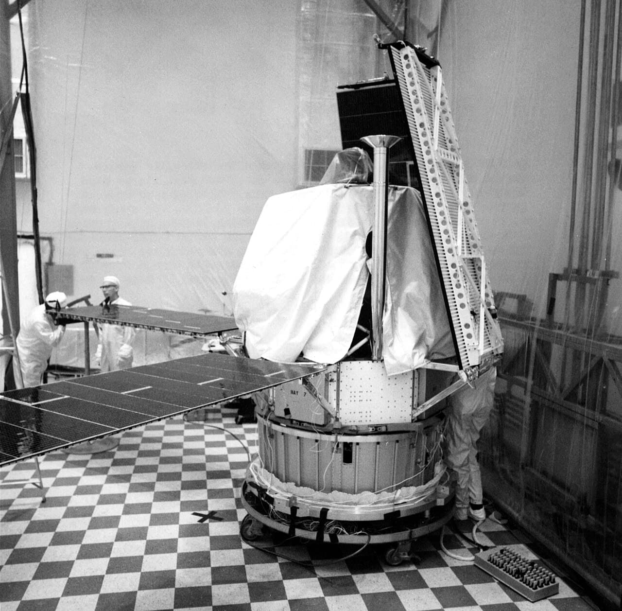 Technicians installing solar panels on the spacecraft then known by its pre-launch letter as Mariner H, in a clean room at Cape Kennedy in 1971. NASA's caption notes it would be designated Mariner 8 following launch.