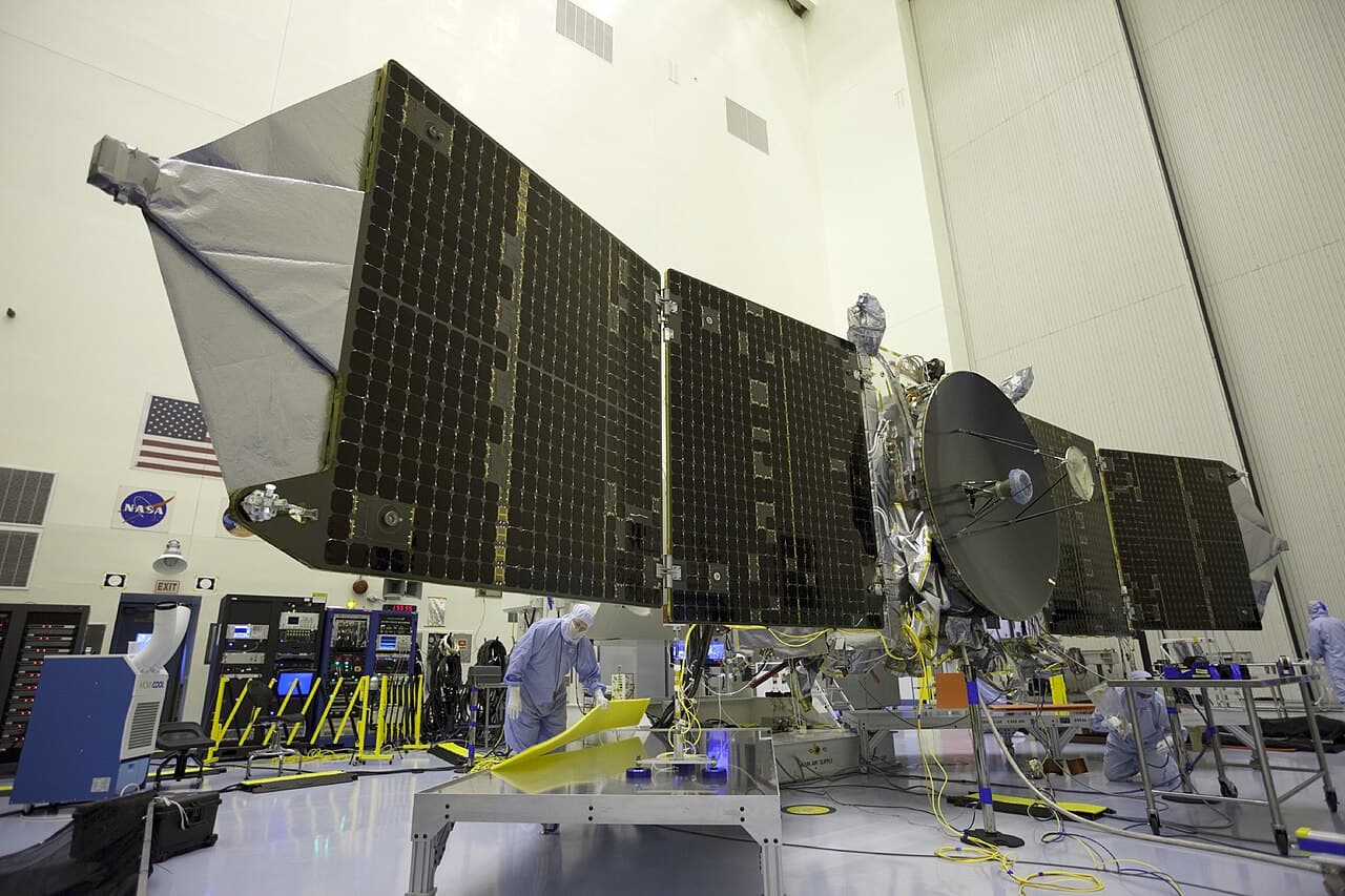 Engineers and technicians test deploy MAVEN's twin solar arrays inside the Payload Hazardous Servicing Facility at NASA's Kennedy Space Center on 23 September 2013, about eight weeks before launch.