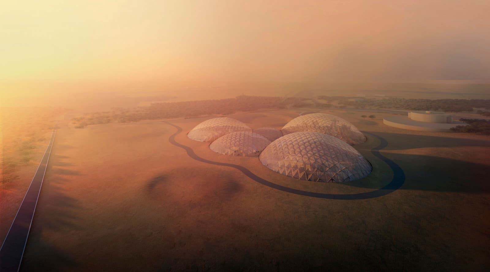 BIG's aerial visualisation of Mars Science City as it would sit in the desert outside Dubai, five geodesic domes clustered on a green plot beside a looping access road, with a highway at the left and a hazy sunrise behind.