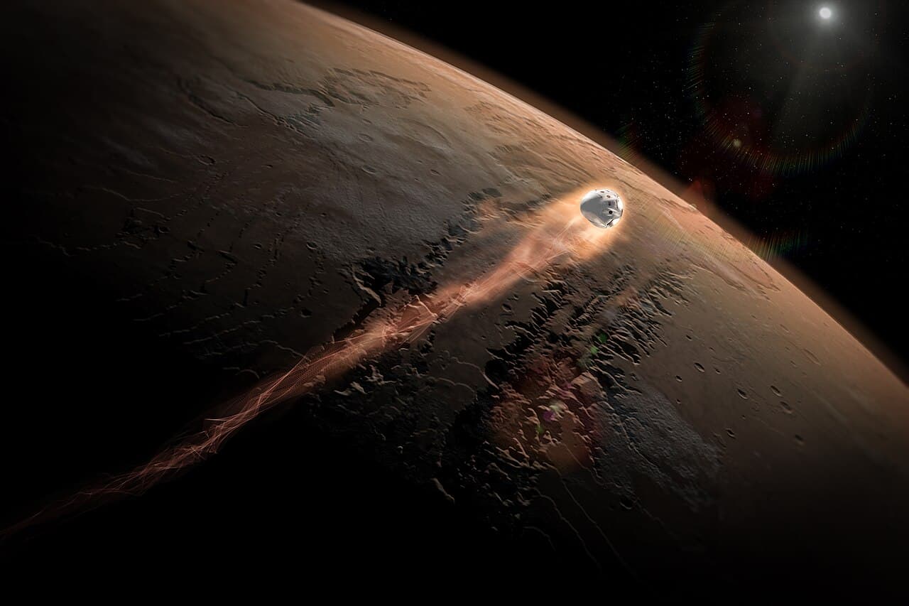 SpaceX concept art titled Dragon to Mars, showing a Dragon capsule glowing white hot as it enters the martian atmosphere at hypersonic speed, dragging a long incandescent wake across the sunlit face of the planet with the canyon system of Valles Marineris below it.