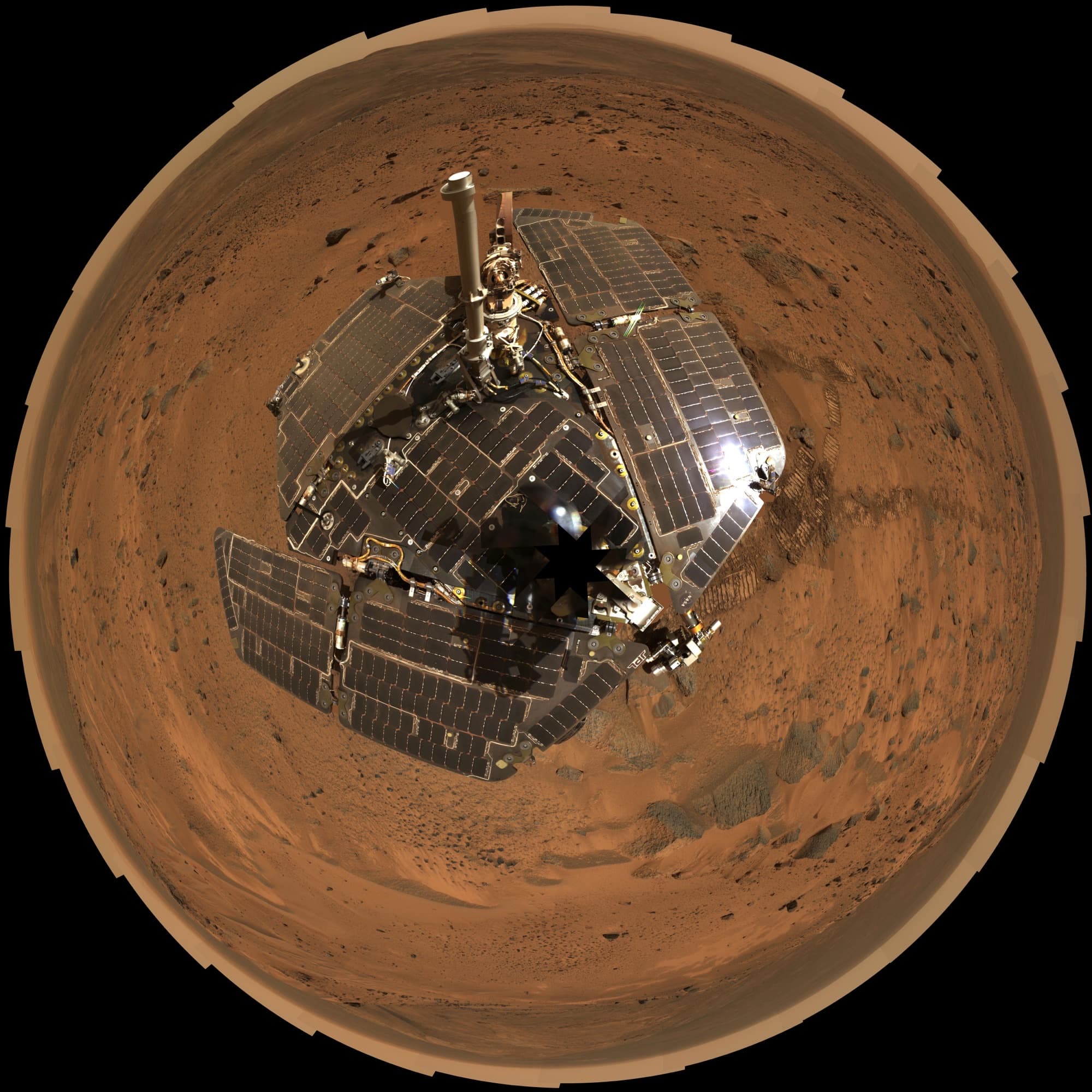 PIA03275, a polar-projection mosaic that combines a self-portrait of Spirit's deck with the 360-degree panorama the rover shot from the true summit of Husband Hill over sols 583 to 586, 24 to 27 August 2005.