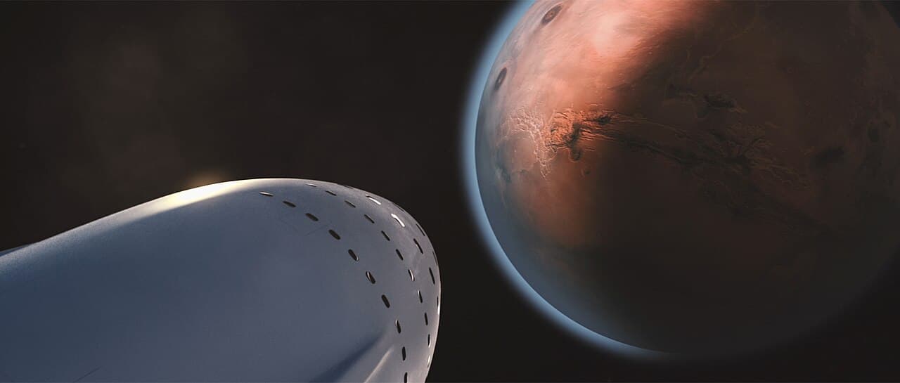 SpaceX's own render of the 2016 Interplanetary Transport System, published by the company on 27 September 2016 with the caption 'Interplanetary Spaceship, arriving Mars'. The nose and upper hull of the vehicle fill the lower left of the frame, its thermal tiles picked out as dark dashes along the flank, with Mars beyond it in the upper right of the frame, lit from the right and its terminator crossing the lower left of the disc.