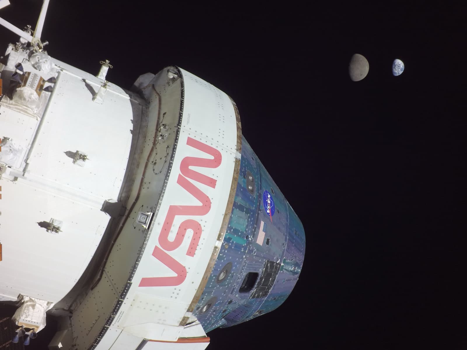 The Orion spacecraft with the Moon and a distant Earth in the same frame