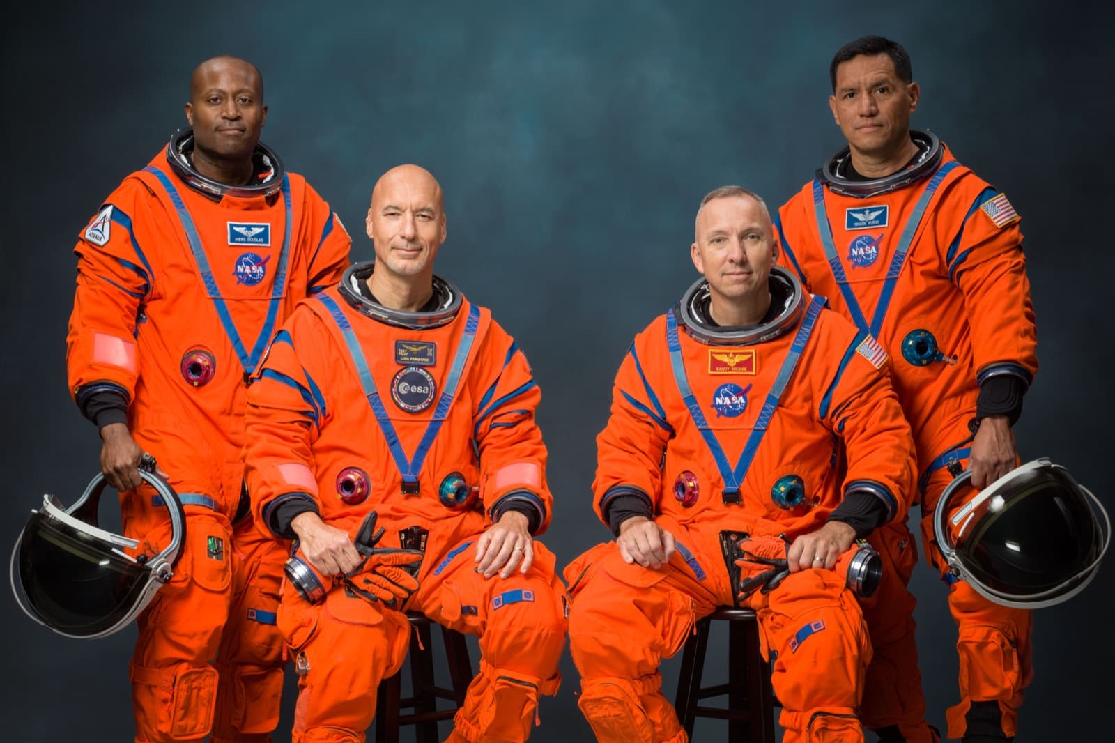 The four Artemis III astronauts in orange Orion Crew Survival System suits