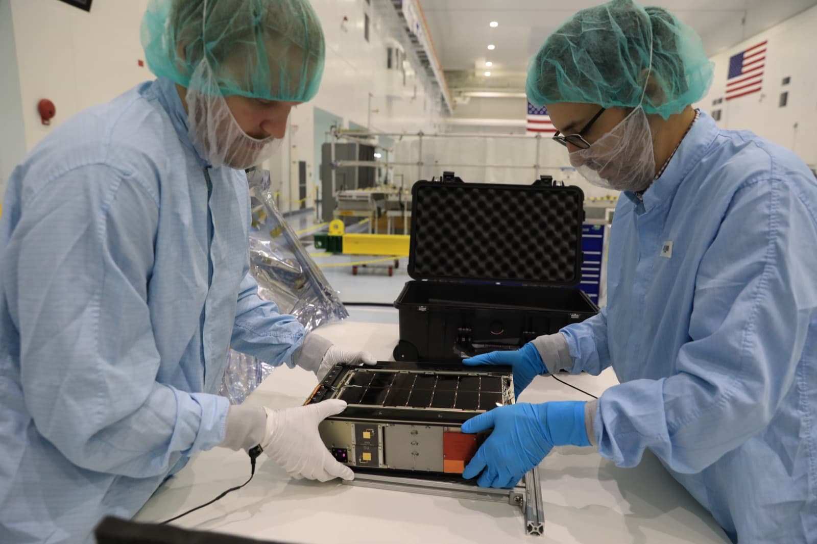 A team prepares the LunaH-Map CubeSat for installation in the Orion stage adapter ahead of Artemis I