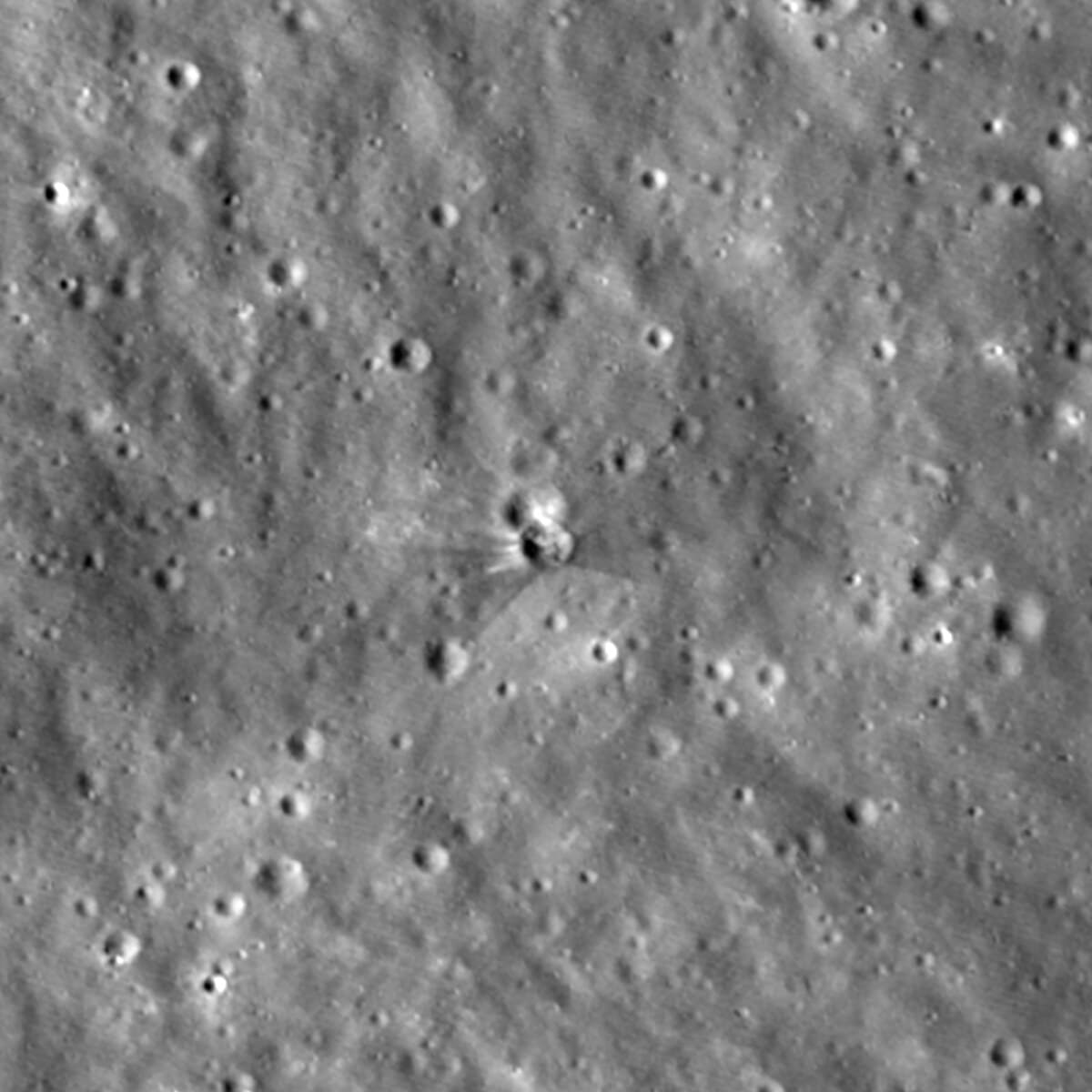 After: the new crater, with bright rays and a dark fan of disturbed ground around it